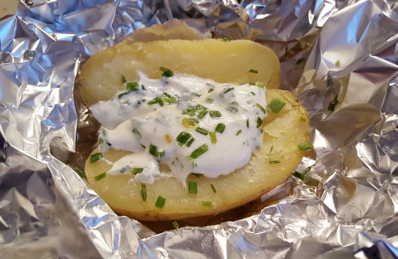 aluminum foil with baked potatoes