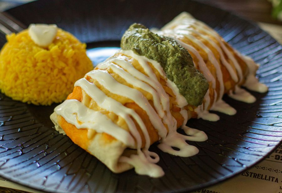 chimichanga with cheese sauce guacamole and rice